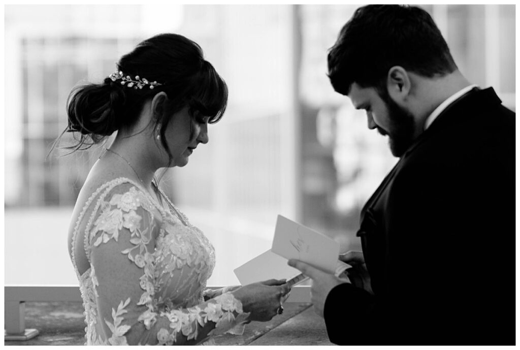 bride and groom read vows to each other by Charlotte wedding photographer