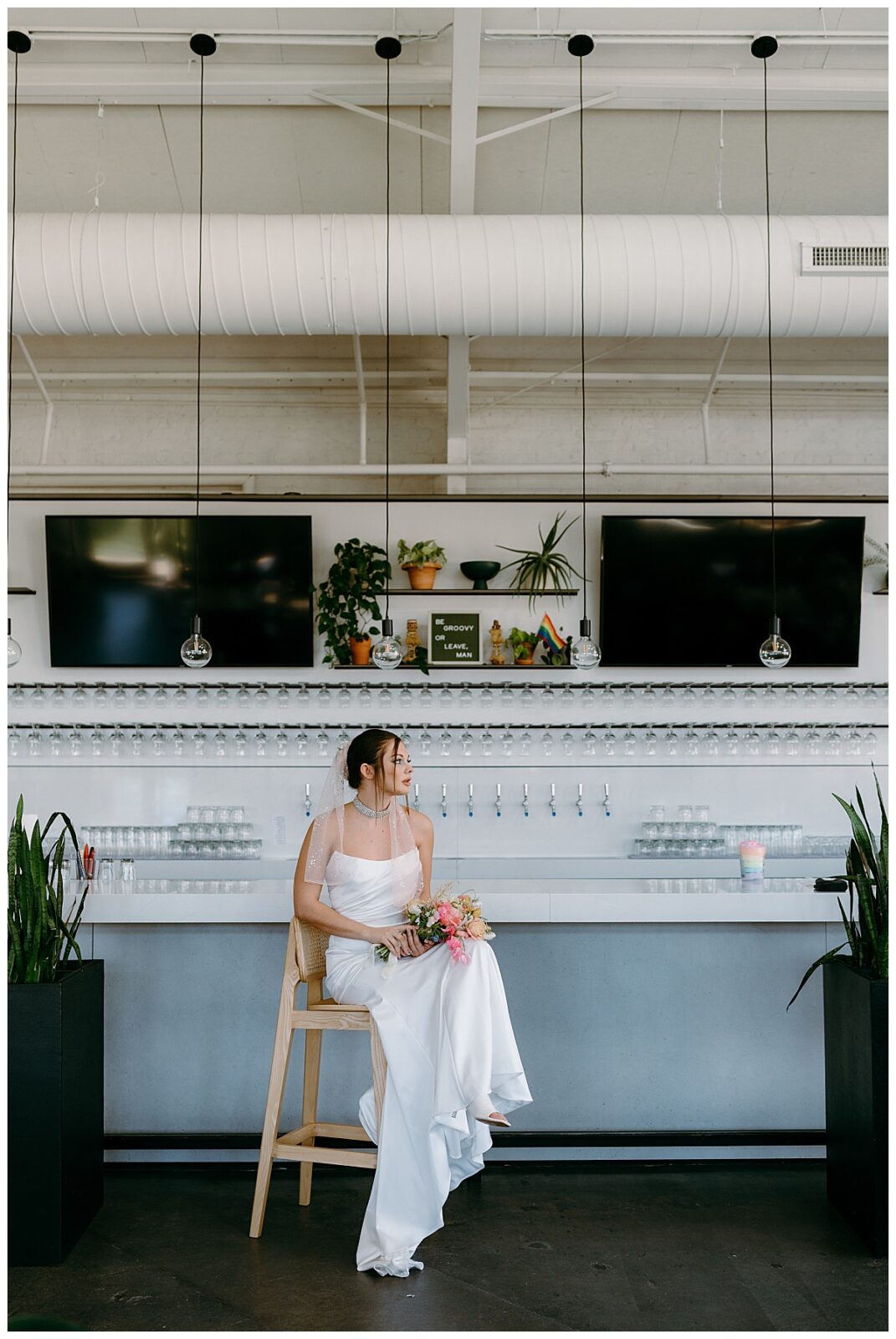 woman sits at bar at Junction West styled shoot