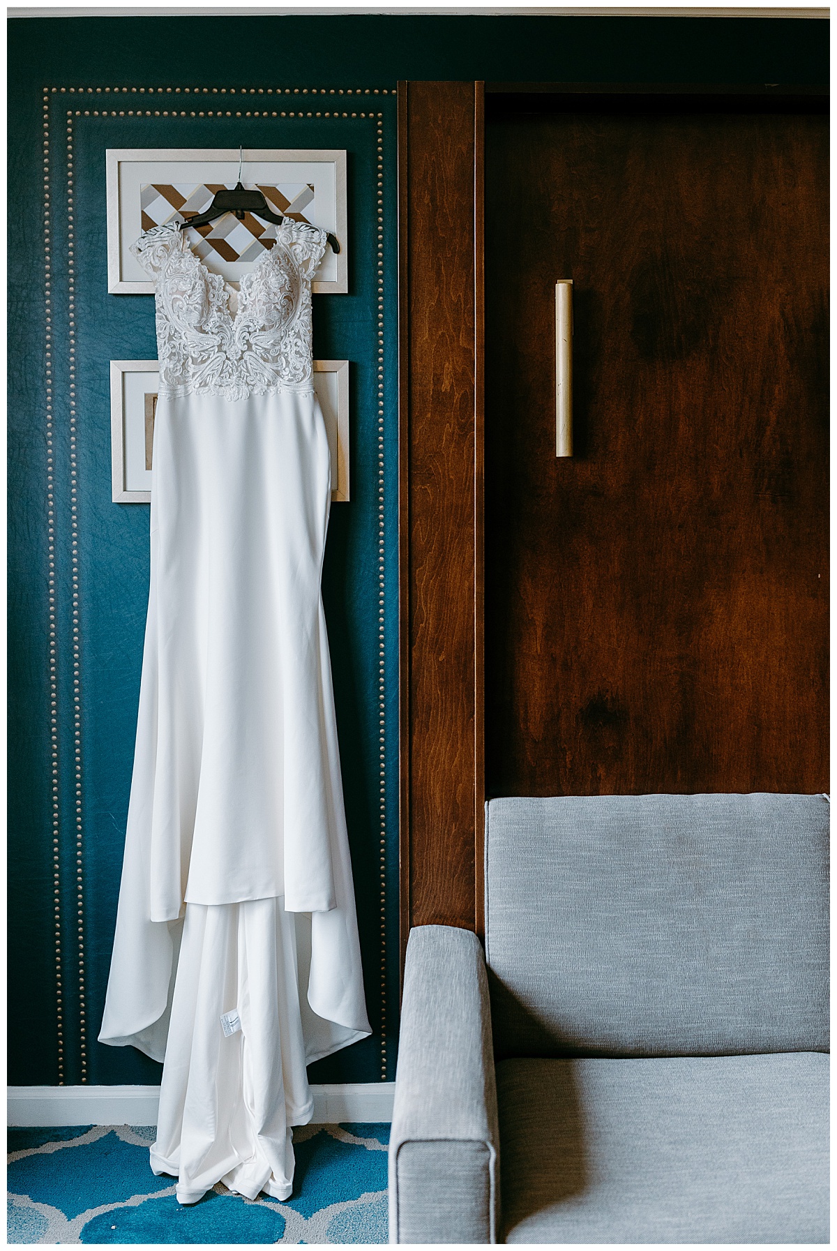 bridal gown hangs on teal wall at Toolbox DC