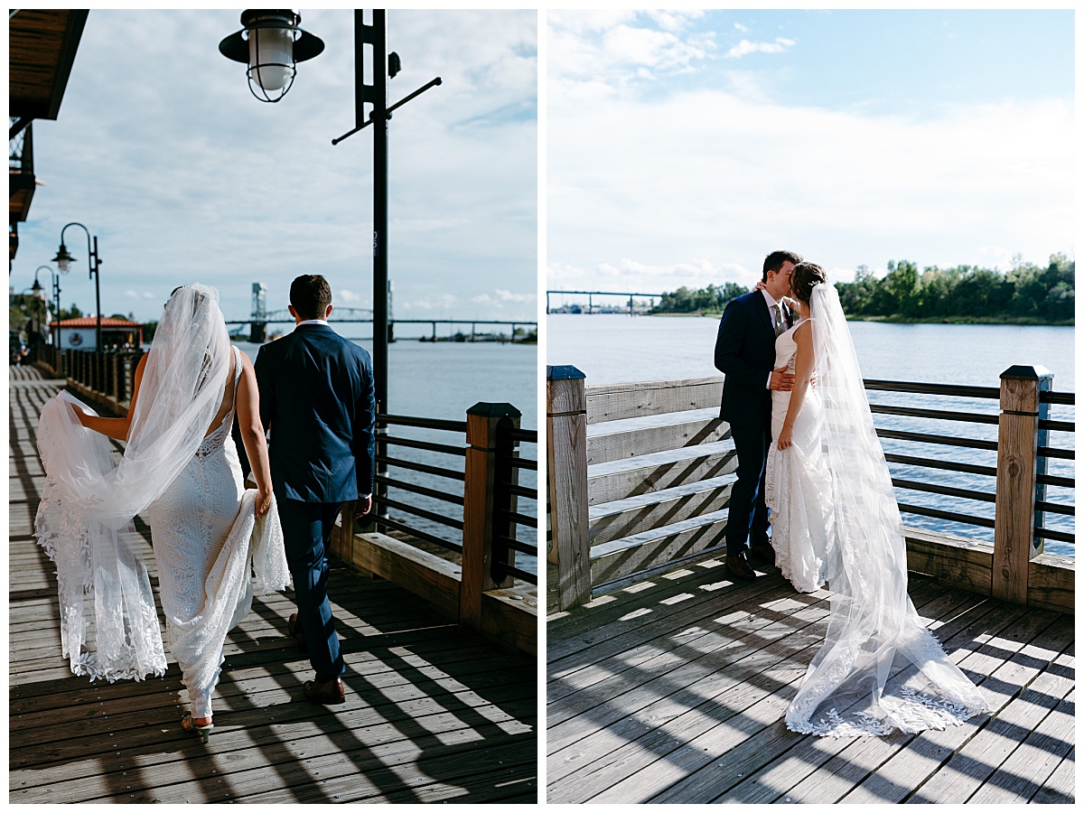 newlyweds walk along boardwalk by river by North Carolina wedding photographer