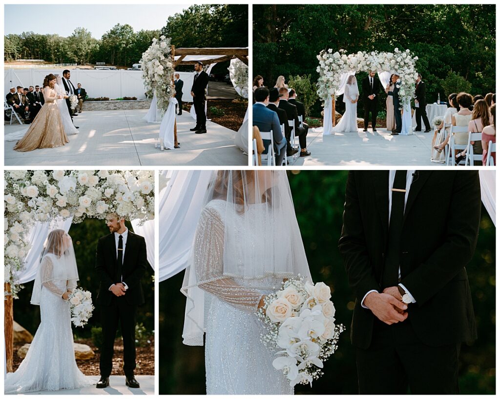bride and groom stand under chuppah covered in white flowers at modern barn ceremony