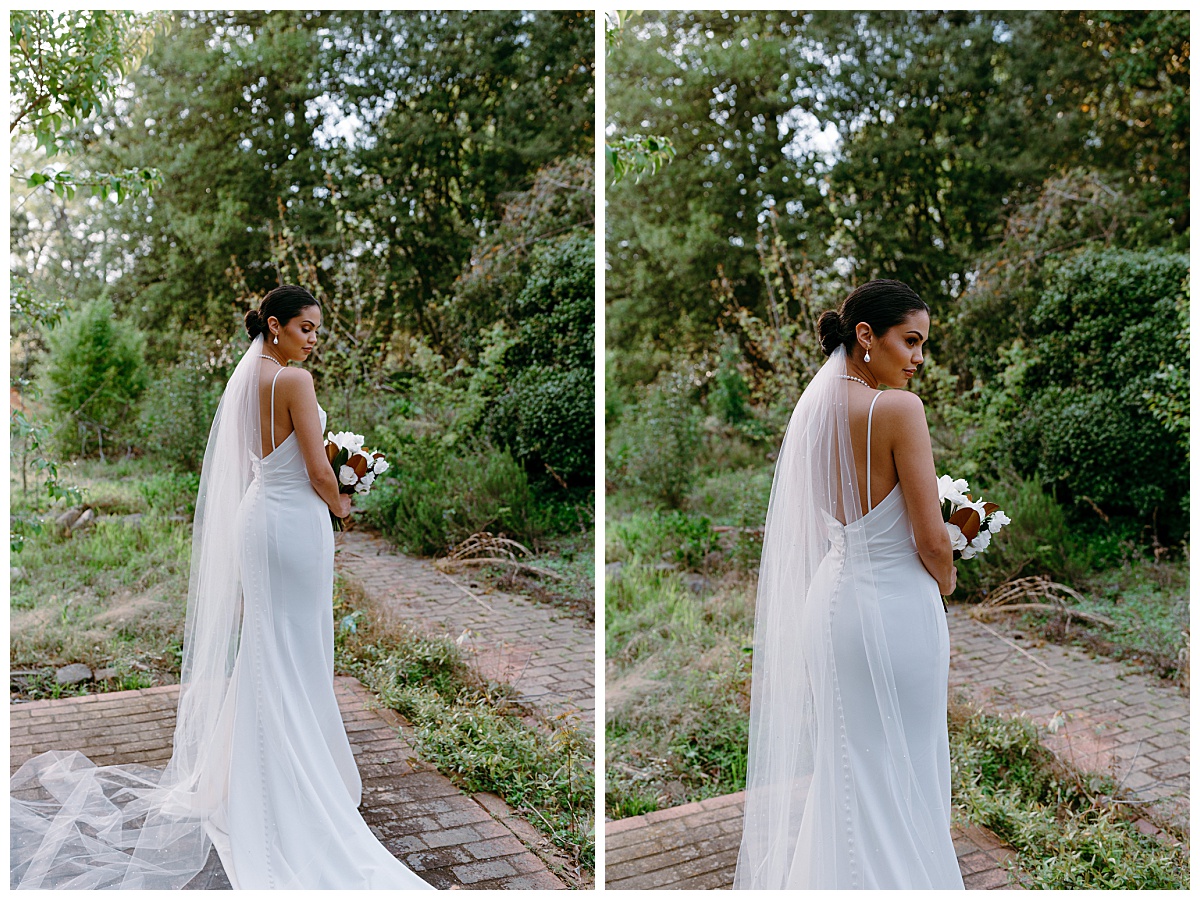 bride in long veil looks over shoulder by Charlotte wedding photographer
