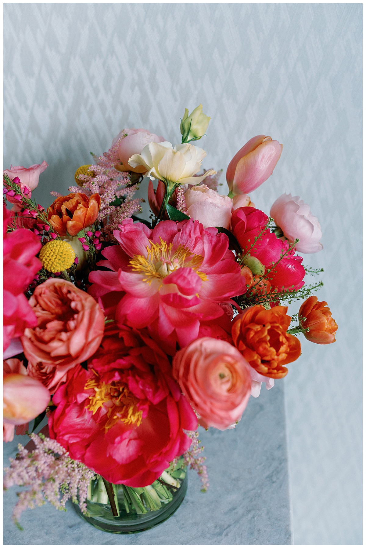 floral centerpiece include bright pink and orange flowers by Charlotte wedding photographer