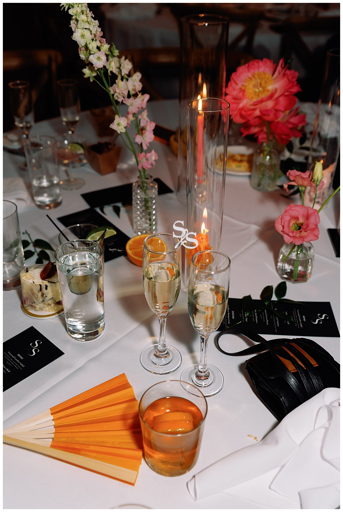 reception decor includes florals in small vases, candles, and monogramed champaign flutes by The Hazel Club